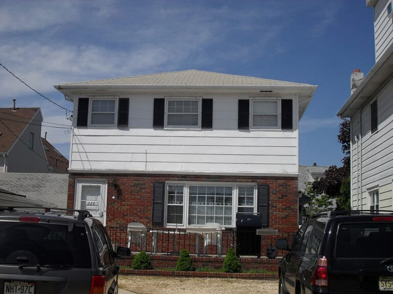 Beach house inspected by Checkmark Plus: white house with garage