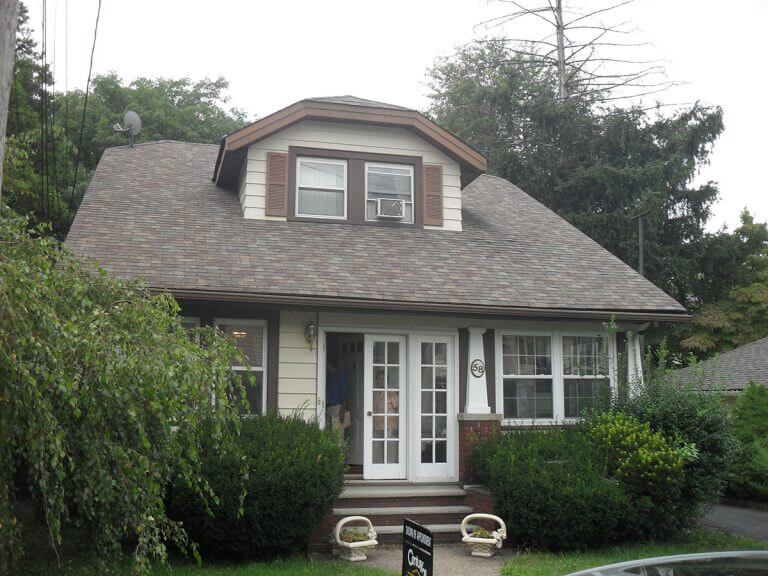 Two-family house inspected by Checkmark Plus: brown roof cape