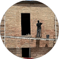 Google reviewer photo, person by a brick building